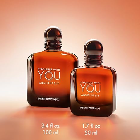Two bottles of Emporio Armani perfume with a warm gradient background