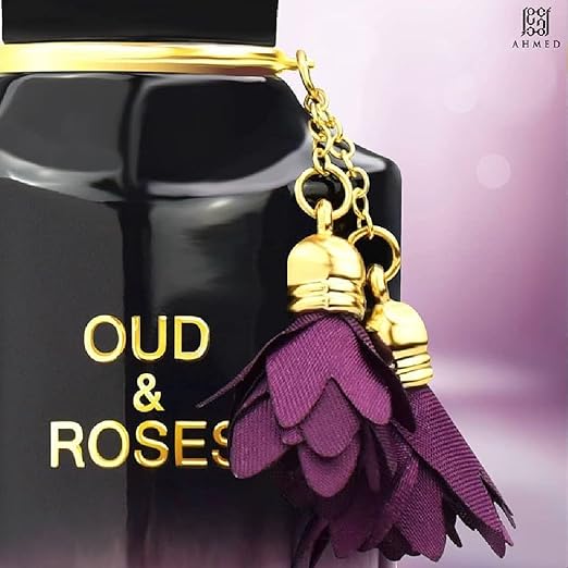 Perfume bottle with 'Oud & Roses' text and purple tassel on a blurred background
