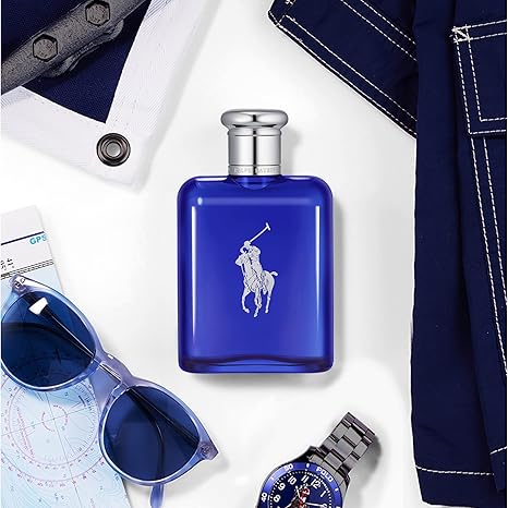 Blue Polo Ralph Lauren perfume bottle with sunglasses, watch, and jeans on a white background
